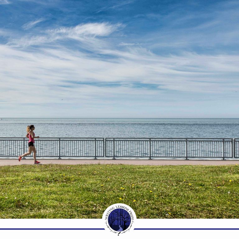 Writing Lessons From... My Local Running Club: A photo of a woman running along the coast, beautiful blue sky and sea and green grass.
